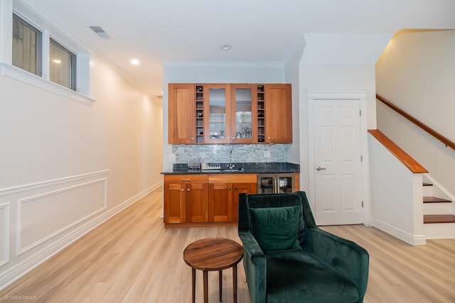 2418 N Southport Ave Unit 1, Chicago, IL 60614 - indoor wet bar featuring light wood-type flooring, tasteful backsplash, ornamental molding, stairway, and recessed lighting