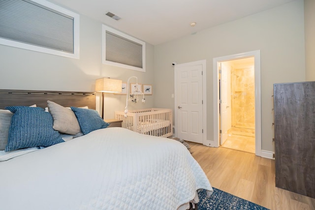 2418 N Southport Ave Unit 1, Chicago, IL 60614 - bedroom with light wood-style flooring and connected bathroom
