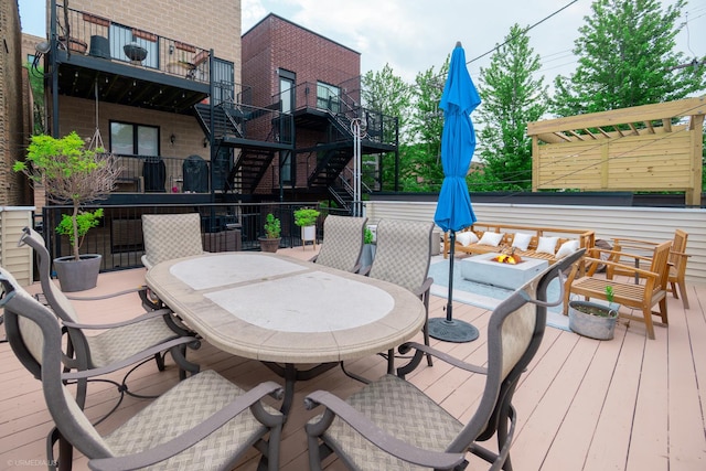 2418 N Southport Ave Unit 1, Chicago, IL 60614 - wooden deck featuring stairs, outdoor dining space, and an outdoor living space with a fire pit