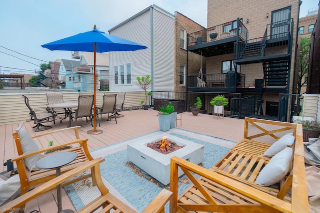 2418 N Southport Ave Unit 1, Chicago, IL 60614 - wooden deck with a fire pit, outdoor dining space, and stairs