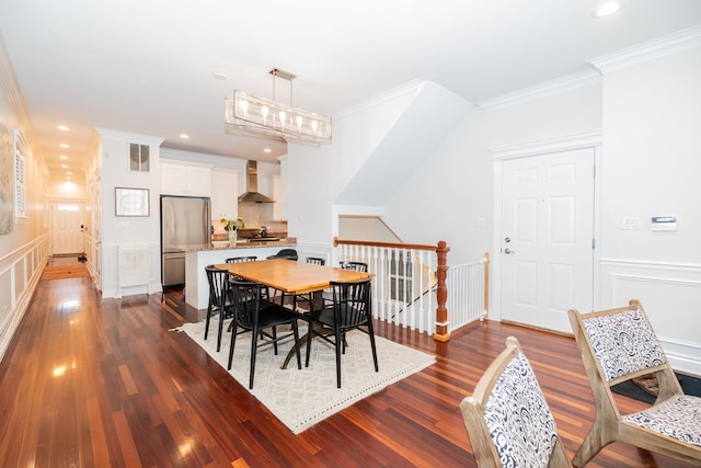 2418 N Southport Ave Unit 1, Chicago, IL 60614 - dining room with dark wood-style flooring, ornamental molding, a wainscoted wall, and a decorative wall