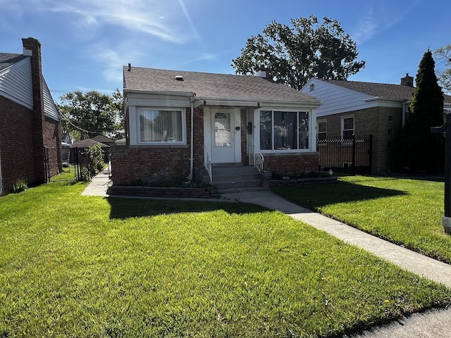 103 Morris St, Bellwood, IL 60104 - bungalow-style home featuring a gate, brick siding, and roof with shingles