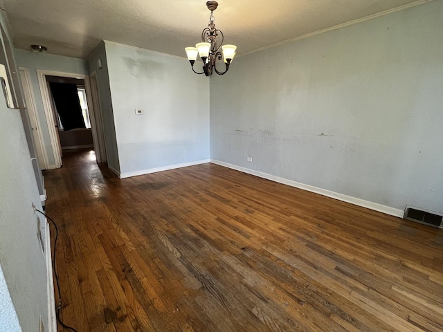 103 Morris St, Bellwood, IL 60104 - spare room with dark wood-type flooring, a chandelier, and crown molding
