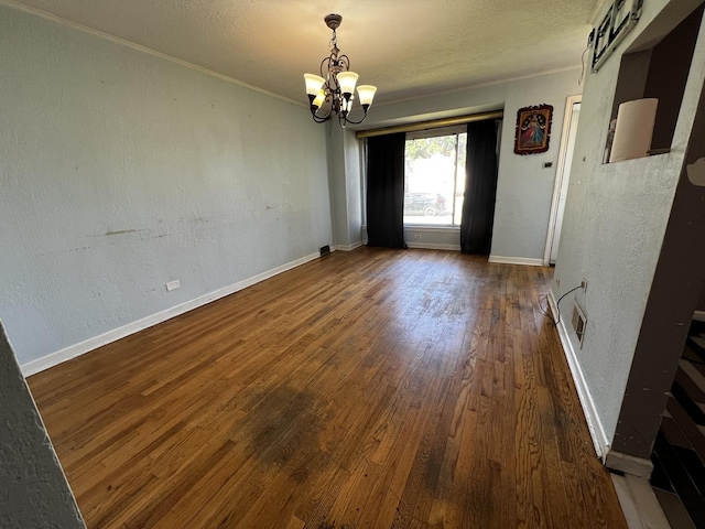 103 Morris St, Bellwood, IL 60104 - unfurnished dining area featuring a chandelier, wood finished floors, a textured ceiling, ornamental molding, and a textured wall