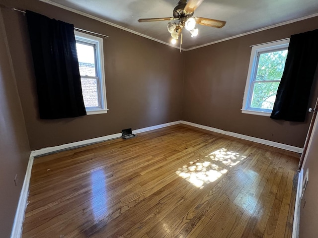 103 Morris St, Bellwood, IL 60104 - empty room featuring wood-type flooring, healthy amount of natural light, ornamental molding, and a ceiling fan