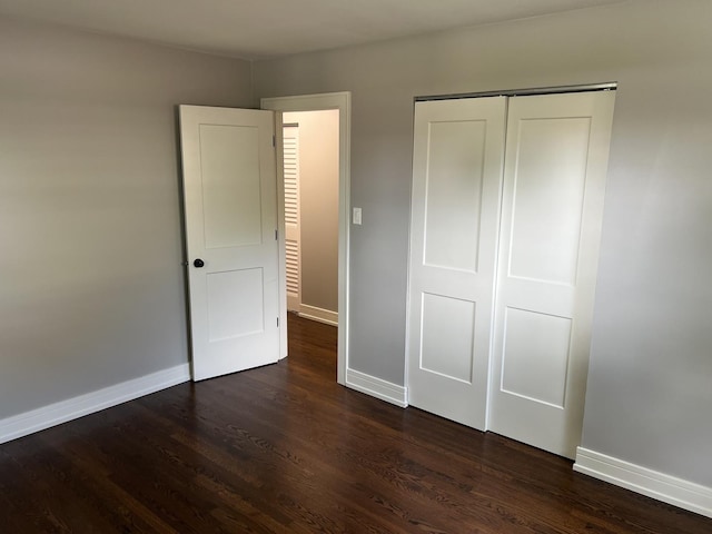 9128 Homestead Ln, Bridgeview, IL 60455 - unfurnished bedroom with dark wood-style floors and a closet