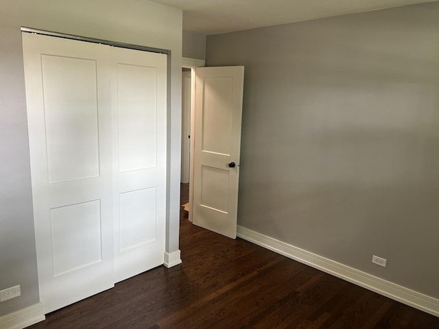 9128 Homestead Ln, Bridgeview, IL 60455 - unfurnished bedroom with dark wood-style flooring and a closet