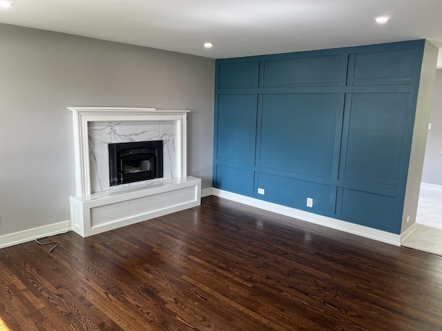 9128 Homestead Ln, Bridgeview, IL 60455 - unfurnished living room with dark wood-type flooring, recessed lighting, a high end fireplace, and a decorative wall