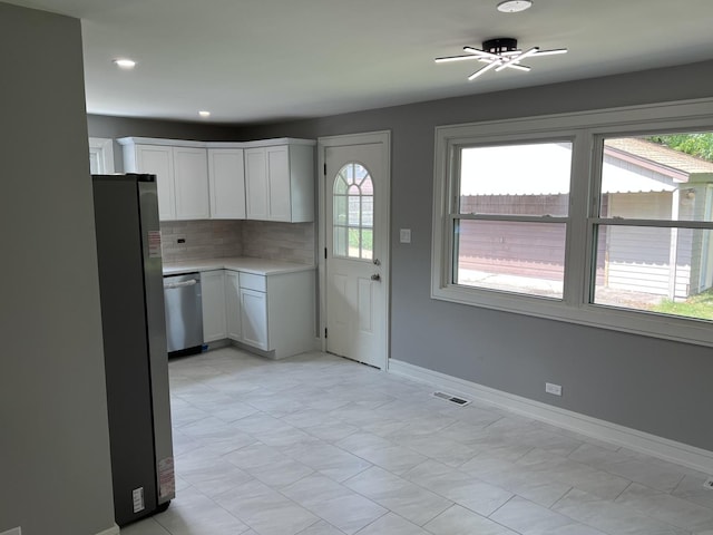 9128 Homestead Ln, Bridgeview, IL 60455 - kitchen featuring stainless steel appliances, decorative backsplash, light countertops, white cabinets, and recessed lighting