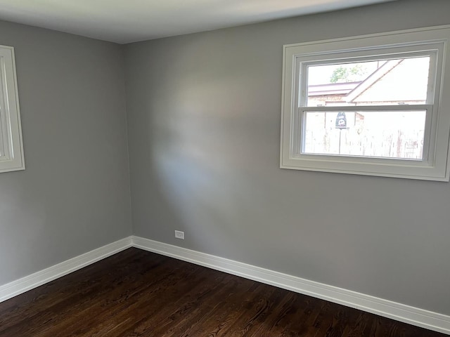 9128 Homestead Ln, Bridgeview, IL 60455 - empty room with baseboards and dark wood-type flooring