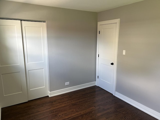 9128 Homestead Ln, Bridgeview, IL 60455 - unfurnished bedroom with dark wood-style flooring and a closet
