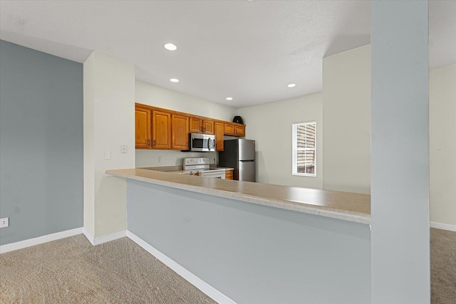 3718 Thornhill Dr Unit 0, Champaign, IL 61822 - kitchen with appliances with stainless steel finishes, carpet floors, light countertops, recessed lighting, and a peninsula
