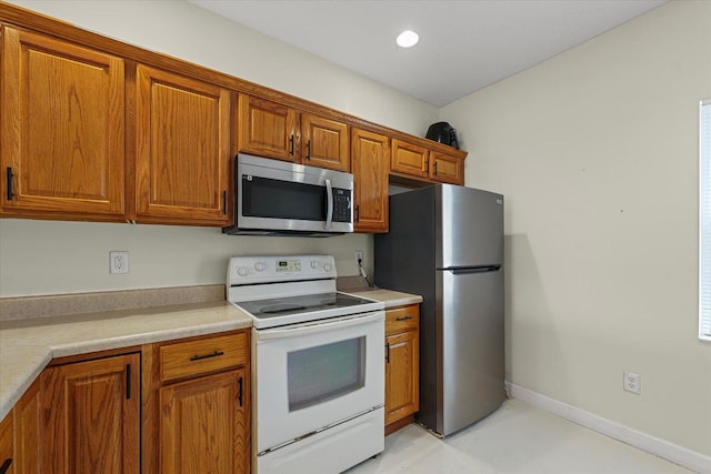 3718 Thornhill Dr Unit 0, Champaign, IL 61822 - kitchen with appliances with stainless steel finishes, brown cabinets, light countertops, and recessed lighting