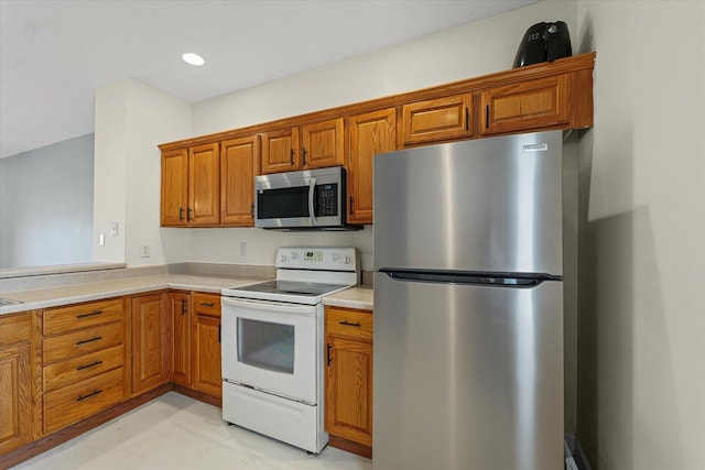3718 Thornhill Dr Unit 0, Champaign, IL 61822 - kitchen featuring appliances with stainless steel finishes, brown cabinetry, light countertops, and recessed lighting