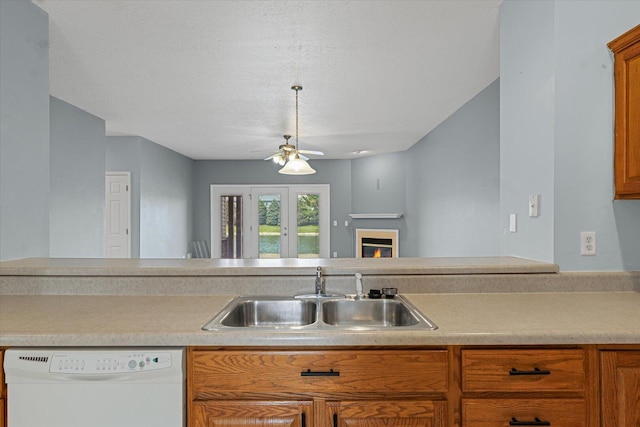3718 Thornhill Dr Unit 0, Champaign, IL 61822 - kitchen with white dishwasher, a ceiling fan, brown cabinetry, light countertops, and a textured ceiling