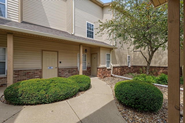 3718 Thornhill Dr Unit 0, Champaign, IL 61822 - view of exterior entry with brick siding and a porch