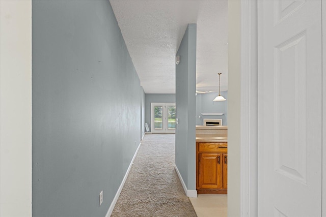 3718 Thornhill Dr Unit 0, Champaign, IL 61822 - corridor with light carpet, a textured ceiling, and french doors