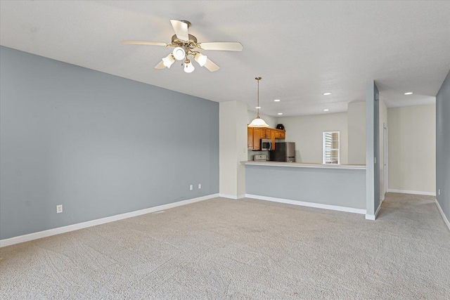 3718 Thornhill Dr Unit 0, Champaign, IL 61822 - unfurnished living room with light carpet, a ceiling fan, and recessed lighting