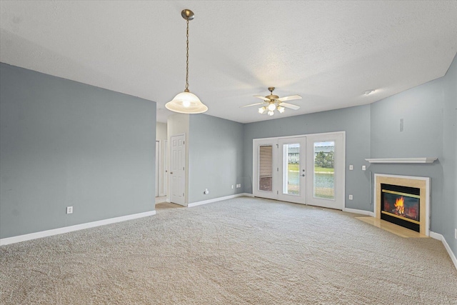 3718 Thornhill Dr Unit 0, Champaign, IL 61822 - unfurnished living room featuring ceiling fan, carpet flooring, a fireplace with flush hearth, and a textured ceiling