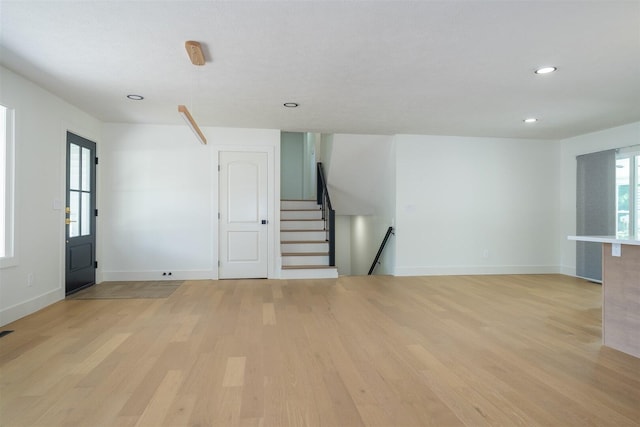 1717 Liston Ct, Normal, IL 61761 - unfurnished living room featuring light wood-style flooring, recessed lighting, and stairway