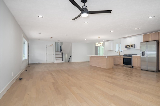 1717 Liston Ct, Normal, IL 61761 - unfurnished living room with recessed lighting, light wood-style floors, a chandelier, stairs, and a ceiling fan