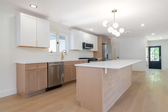 1717 Liston Ct, Normal, IL 61761 - kitchen featuring appliances with stainless steel finishes, light wood-type flooring, a center island, recessed lighting, and light countertops