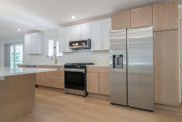 1717 Liston Ct, Normal, IL 61761 - kitchen with stainless steel appliances, light countertops, light wood-style floors, light brown cabinetry, and recessed lighting
