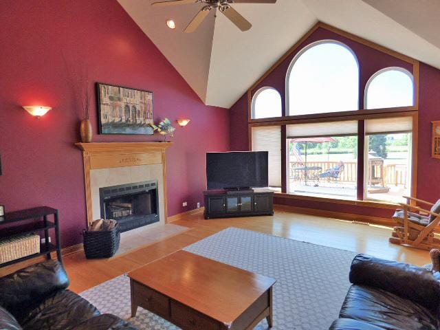 41W951 Hunters Hill Dr, Saint Charles, IL 60175 - living room featuring wood finished floors, ceiling fan, a tile fireplace, and high vaulted ceiling