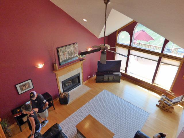 41W951 Hunters Hill Dr, Saint Charles, IL 60175 - living room featuring a fireplace with flush hearth, wood finished floors, a ceiling fan, high vaulted ceiling, and recessed lighting