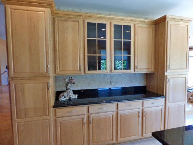 41W951 Hunters Hill Dr, Saint Charles, IL 60175 - kitchen with glass insert cabinets, dark stone counters, and light brown cabinetry