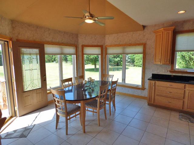 41W951 Hunters Hill Dr, Saint Charles, IL 60175 - dining space featuring ceiling fan, light tile patterned floors, and vaulted ceiling