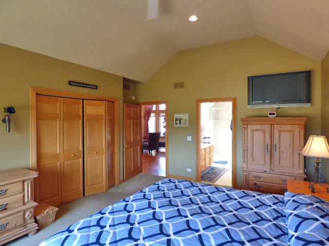 41W951 Hunters Hill Dr, Saint Charles, IL 60175 - bedroom featuring light colored carpet, lofted ceiling, a closet, and ceiling fan