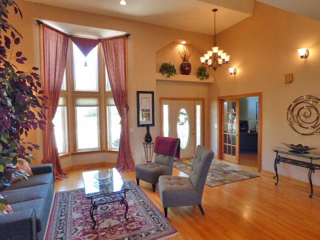 41W951 Hunters Hill Dr, Saint Charles, IL 60175 - living room with wood finished floors, a chandelier, and a towering ceiling