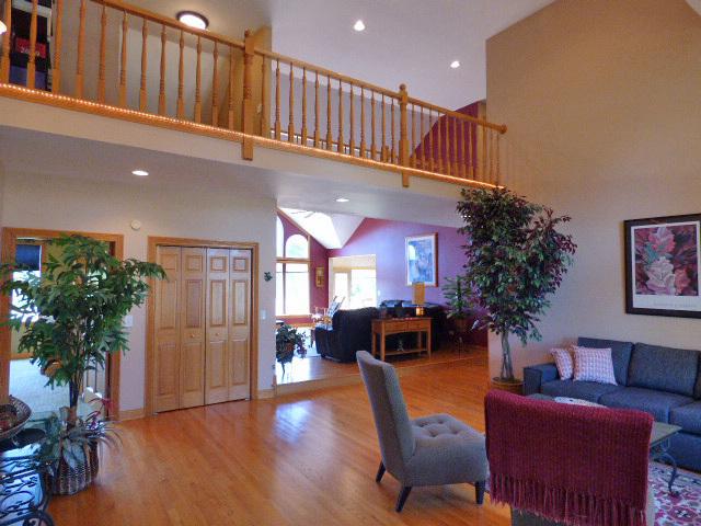 41W951 Hunters Hill Dr, Saint Charles, IL 60175 - living room featuring wood finished floors, a towering ceiling, and recessed lighting