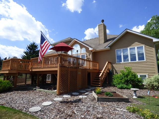 41W951 Hunters Hill Dr, Saint Charles, IL 60175 - back of property featuring stairs, a deck, a chimney, and a vegetable garden