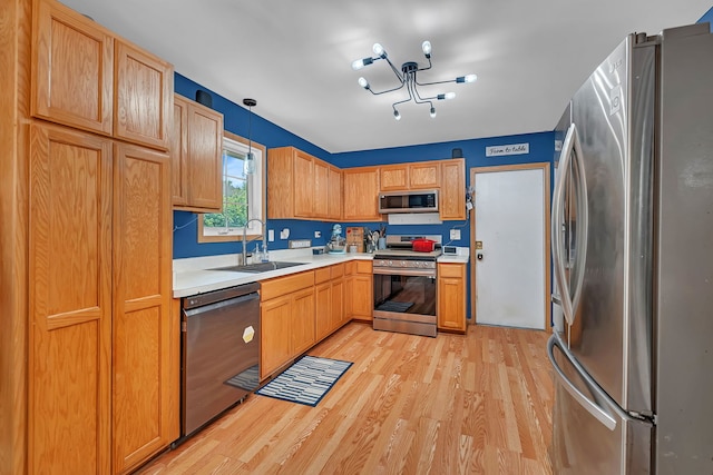 1308 Cumberland Dr, Joliet, IL 60431 - kitchen with appliances with stainless steel finishes, light wood-style flooring, light countertops, and a chandelier
