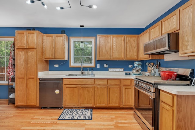 1308 Cumberland Dr, Joliet, IL 60431 - kitchen with stainless steel appliances, light countertops, light wood finished floors, and decorative light fixtures