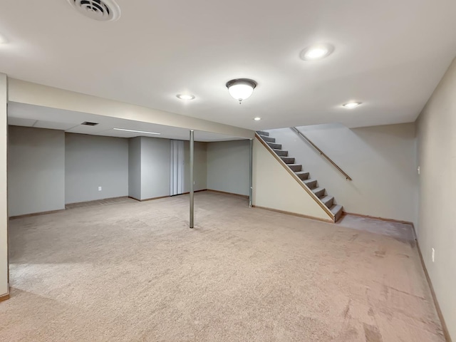 701 E Soper St, Winnebago, IL 61088 - finished basement with light carpet, stairway, and recessed lighting