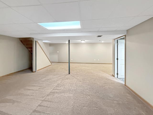 701 E Soper St, Winnebago, IL 61088 - finished below grade area featuring light colored carpet, a paneled ceiling, and stairway