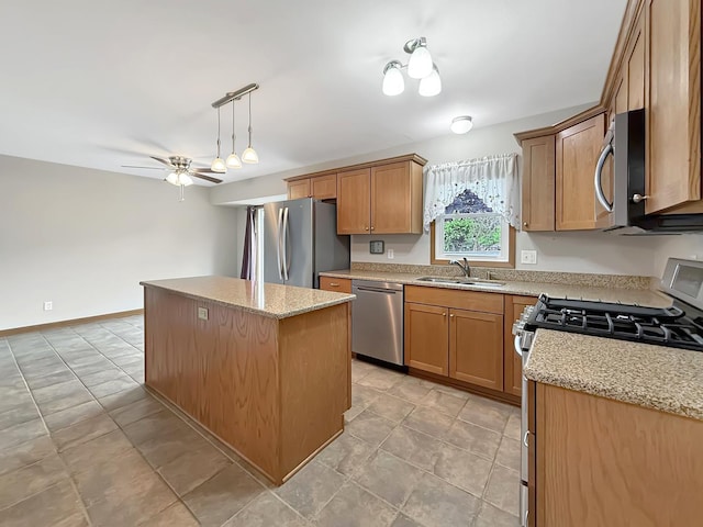 701 E Soper St, Winnebago, IL 61088 - kitchen with stainless steel appliances, a center island, light stone counters, a ceiling fan, and brown cabinets