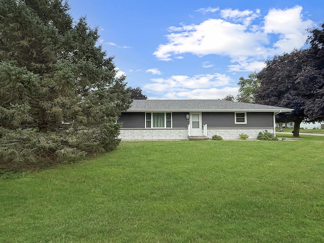 701 E Soper St, Winnebago, IL 61088 - ranch-style home with a front lawn, stone siding, and a shingled roof