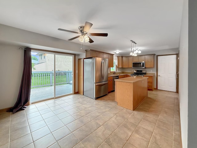 701 E Soper St, Winnebago, IL 61088 - kitchen featuring stainless steel appliances, light countertops, ceiling fan, a center island, and pendant lighting