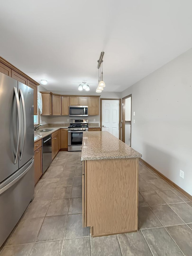 701 E Soper St, Winnebago, IL 61088 - kitchen featuring stainless steel appliances, a center island, light stone counters, decorative light fixtures, and light tile patterned flooring