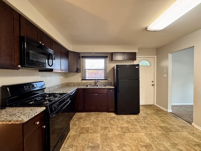 900 W Strieff Ln, Glenwood, IL 60425 - kitchen with black appliances, dark brown cabinetry, and light stone countertops