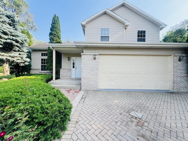 1858 David Ave, Joliet, IL 60433 - traditional-style house featuring brick siding, an attached garage, and decorative driveway
