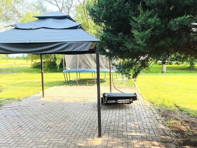 1858 David Ave, Joliet, IL 60433 - view of property's community with a trampoline, a patio area, and a yard
