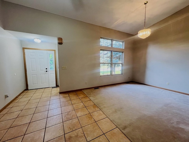 1858 David Ave, Joliet, IL 60433 - entrance foyer with healthy amount of natural light, light tile patterned floors, a chandelier, and light colored carpet