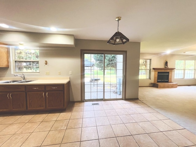1858 David Ave, Joliet, IL 60433 - kitchen with a tiled fireplace, light tile patterned floors, light carpet, light countertops, and open floor plan