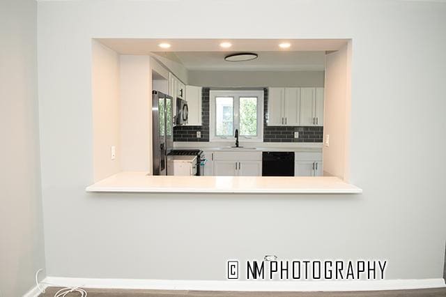 9828 Warren Ave, Oak Lawn, IL 60453 - kitchen featuring stainless steel appliances, decorative backsplash, light countertops, white cabinets, and recessed lighting