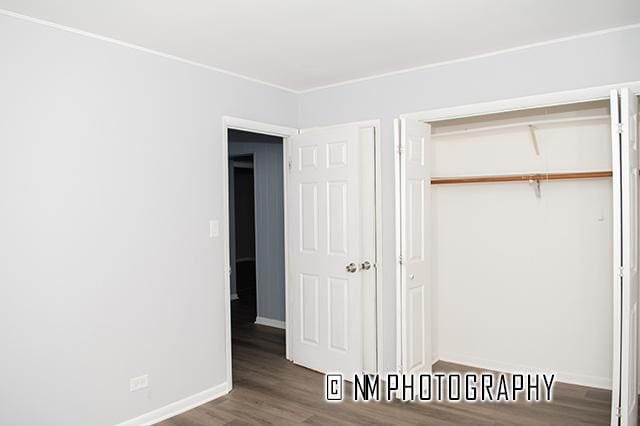 9828 Warren Ave, Oak Lawn, IL 60453 - unfurnished bedroom with wood finished floors and a closet